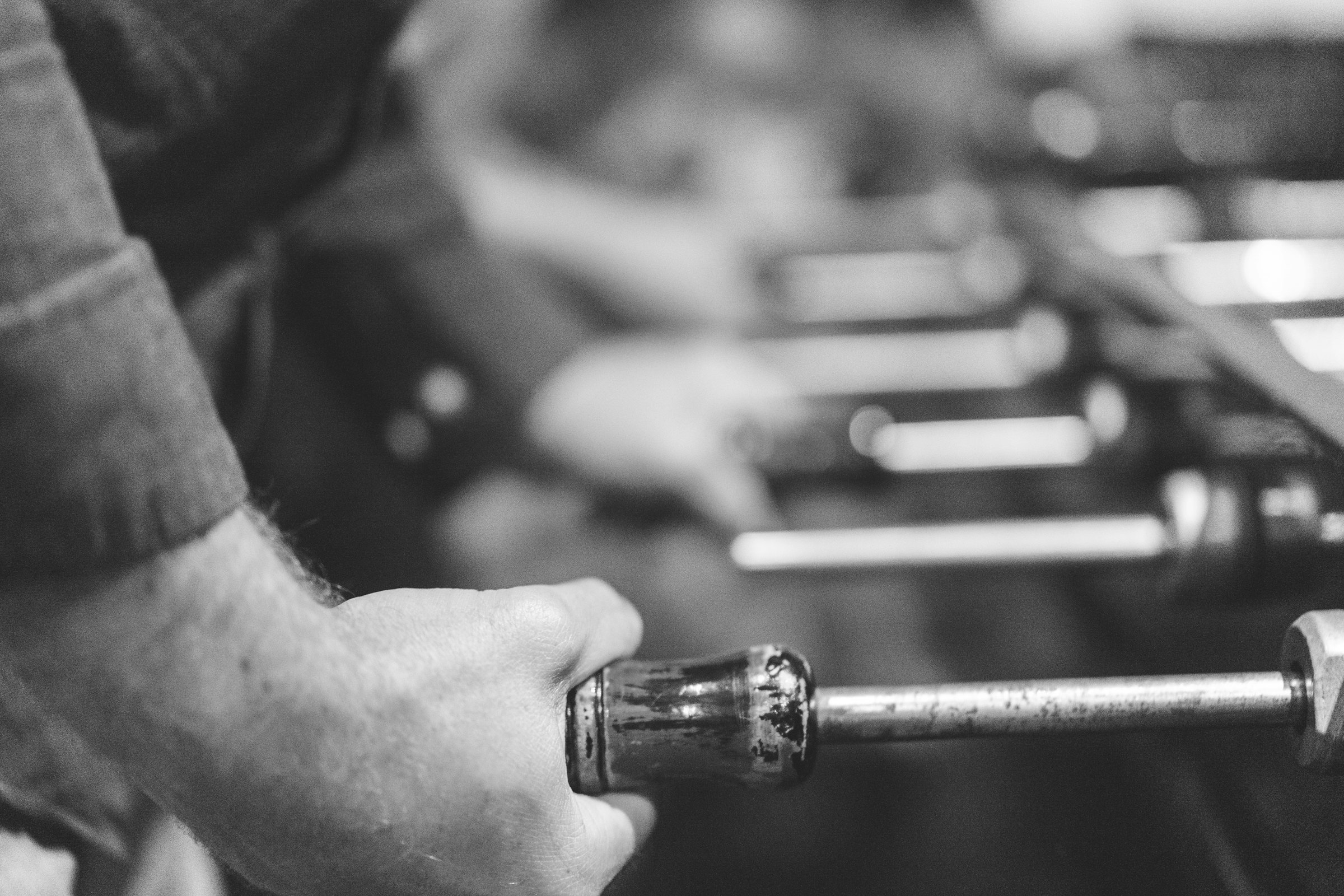 A hand gripping a well-worn tool.